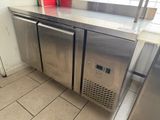 a stainless steel counter top with two red cups on top of it