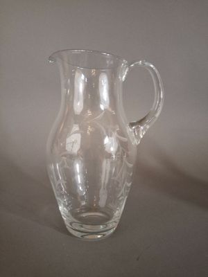a clear glass pitcher sitting on a table