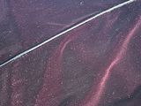 a close up of a car ' s paint job on the side of the road