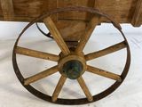 an old fashioned wooden wagon with a wooden seat and wooden wheels