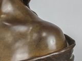 bronze statue of a woman with a shaw around her neck