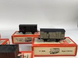 several toy trains sitting on top of each other on a white surface