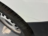 a close up of a tire on a white car