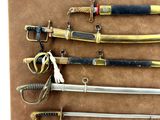 many different types of swords on display on the table