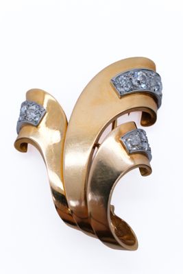 an image of a gold and diamond broochle on a white background