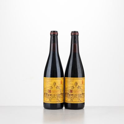 two bottles of beer sitting on top of a table next to each other