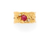 a close up of a gold ring with a ruby stone