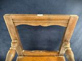 a wooden chair that has a wooden seat on it