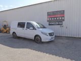 the white van is parked in front of a white building