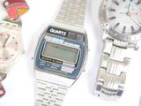 three watches are sitting next to each other on a white surface