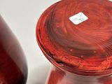 two red vases sitting next to each other on a table