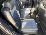two seats in the back of a car that are blue and grey