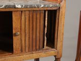 a small table with a marble top next to a chair