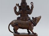 a bronze statue of a man riding a lion on a wooden base