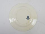 a white plate with a blue crest on it