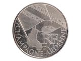 une pièce d'argent sur laquelle est représenté un avion