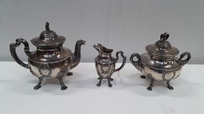 pair of antique silver plated teapots and saucers