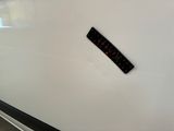 a sticker on the side of a white refrigerator