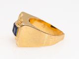 an image of a gold ring with a blue stone in the center