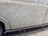a dirty car that is parked on the side of the road