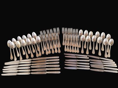 many forks and spoons arranged together on a black background