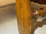 a close up of a wooden chair with a wooden seat