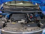a blue car with its hood open and the engine in the trunk