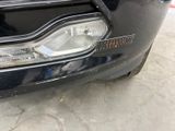 a close up of a car ' s headlight and front bumper