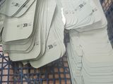 a blue basket filled with lots of cards on top of a wooden floor