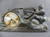 a statue of a man with a gun on top of a clock
