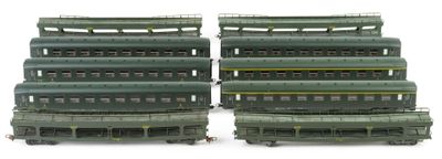 four green train cars sitting next to each other on a white surface