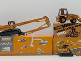 two toy construction vehicles and a box of construction equipment