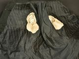 two pairs of gloves that are on a jacket
