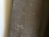 a close up of a suit on a hanger next to a window