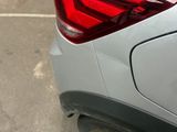 a close up of a car ' s tail light on a parking lot