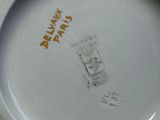 a white plate with a yellow writing on it