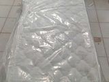 a mattress that is wrapped in plastic on the floor