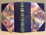 a blue book with a purple cover and a gold bookmark