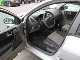 the interior of a car with the door open and the driver ' s seat down