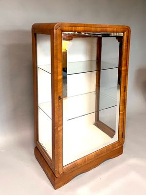a small display case with glass shelves in it