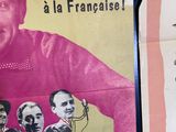 two posters on the wall of a building with pictures of people on them