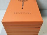 an orange box with a tree on it sitting on top of a table