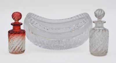 three different glass items sitting on a white surface