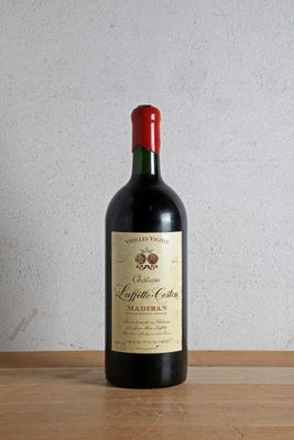 a bottle of wine sitting on a wooden table