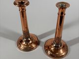 pair of antique brass candlesticks on a white background