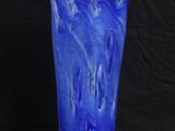 a blue vase that is sitting on a black background
