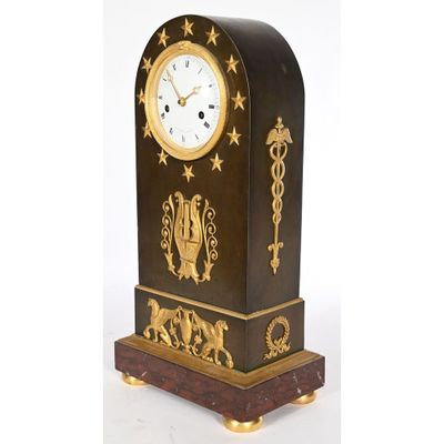 a clock that is sitting on a stand on a white background