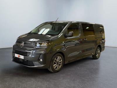 the grey van is parked in a room with a black floor