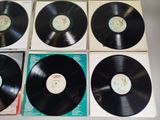 four black vinyl records sitting on top of each other on a table