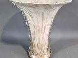 a white vase that is sitting on a table